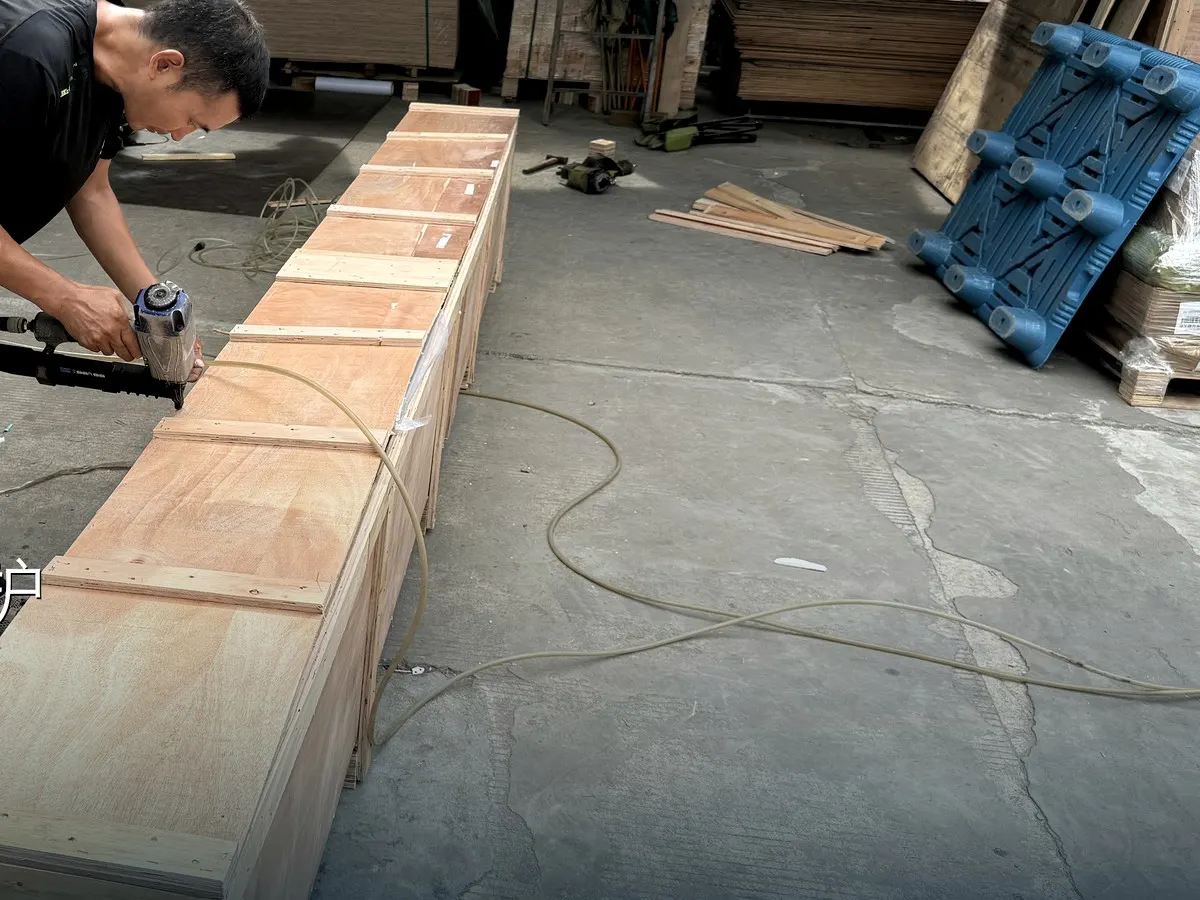 Worker fastening a custom wooden shipping crate