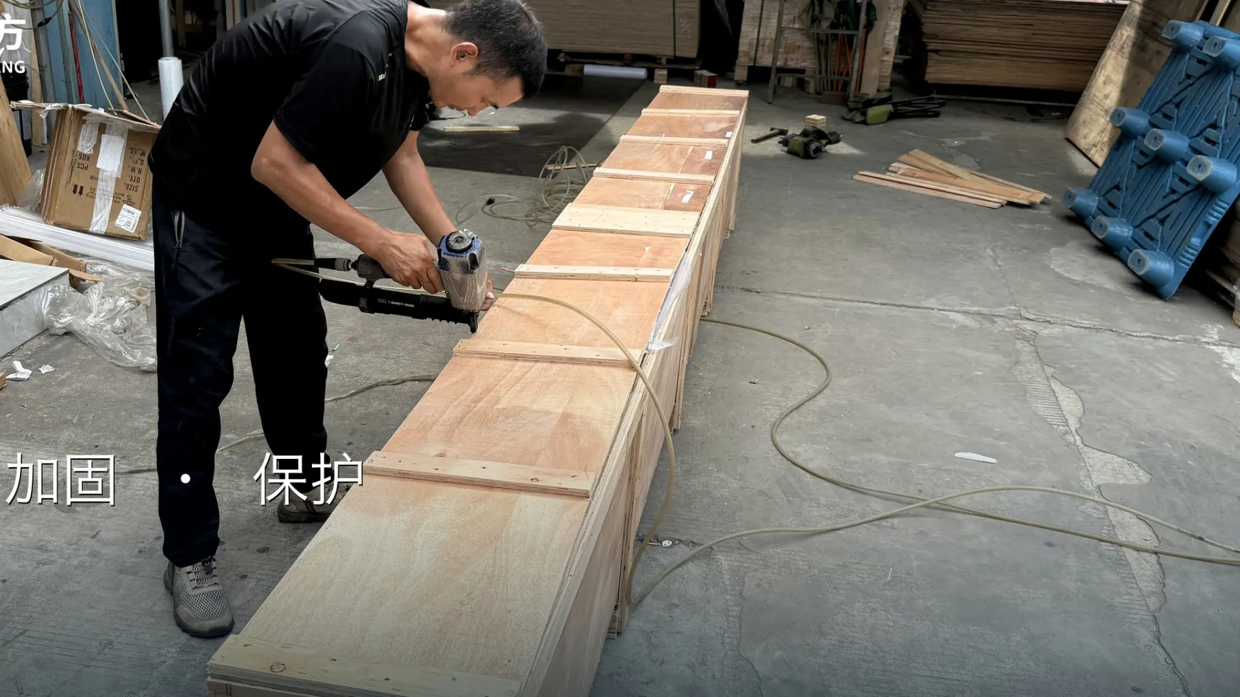 HYHF worker fastening a custom wooden crate